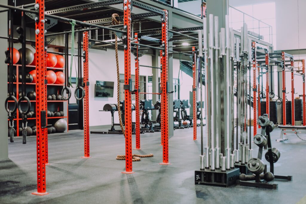 indoor gym with rings, weights, exercise balls and other exercise equipment