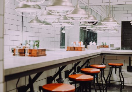 photo of well-lit bathroom with hairdryers